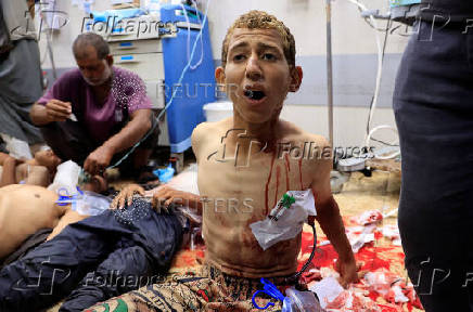 Palestinian casualties of Israeli fire, who were seeking aid, according to medics, are assisted at Nasser Hospital in Khan Younis, southern Gaza Strip