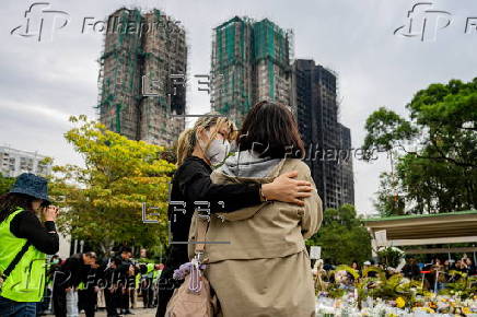 Roadside memorial for victims of the high-rise apartment fire in Hong Kong