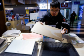 A staffs prepares the laptops for display in a shop at Guang Hua Digital Plaza, a technological and electronics market in Taipei