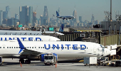 FILE PHOTO: United Airlines planes land and prepare to take off at Newark Liberty International Airport in Newark