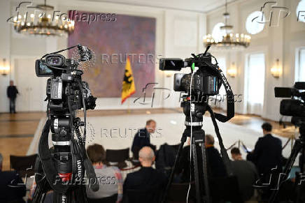 Members of the media wait at Bellevue Palace, as Merz of the CDU fails to be elected chancellor by the German parliament after first voting round, in Berlin