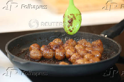 Palestinian-British chef Tamimi prepares bulgur kubbeh dish during interview with Reuters at his home in London