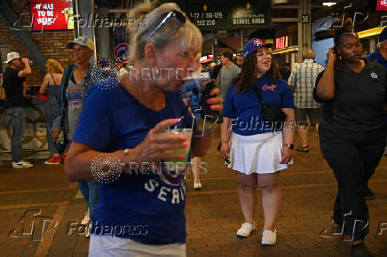 Baseball fans enjoy a while watching Chicago Cubs and the Milwaukee Brewers at Wrigley Field in Chicago