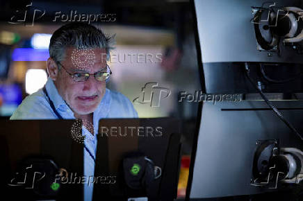 A trader works on the floor at the New York Stock Exchange (NYSE) in New York City