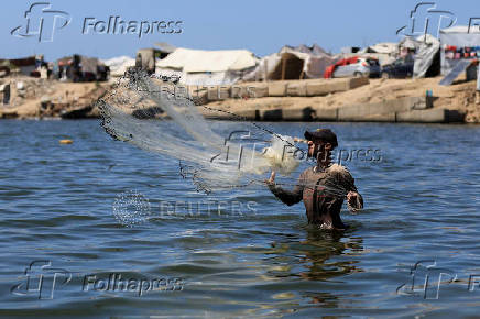 Palestinian fishermen react after Israeli military reiterated an order banning them from entering the sea, in Gaza City