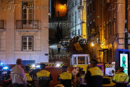 First responders work at the site of a funicular accident in Lisbon