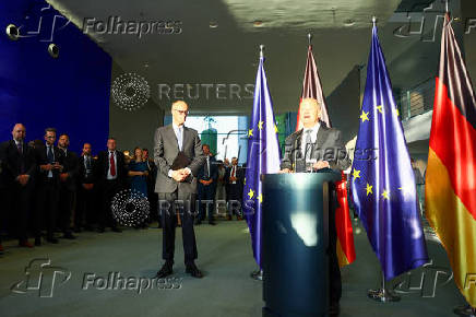 German Chancellor Olaf Scholz hands over to his successor Friedrich Merz