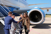 Homeland Security Secretary Kristi Noem, right, shakes hands with staff members before departing Pratica di Mare Air Base near Rome,