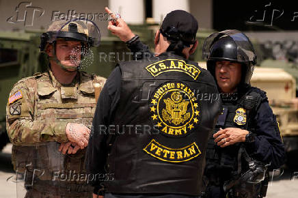 A member of the California National Guard stands outside the Edward R. Roybal Federal Building, in Los Angeles
