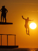 A man jumps into the Adriatic sea during warm weather in Zadar