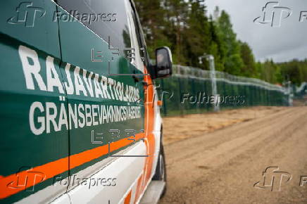 Finnish Border Guard at the barrier fence between Finland and Russia