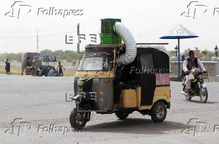 Taxi drivers install locally made air coolers to beat the heat in Kandahar