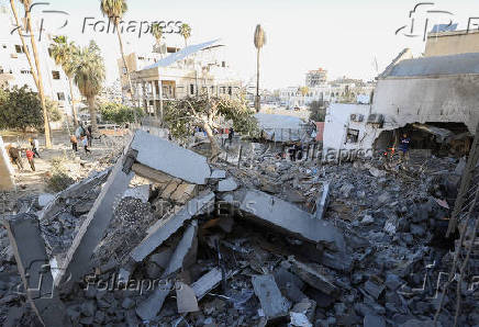 Palestinians inspect damage inside the Al-Ahli Arab Baptist Hospital in Gaza City