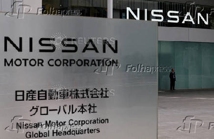 FILE PHOTO: A man stands in front of the global headquarters of Nissan Motor while its annual shareholder meeting is being held in Yokohama