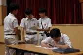 Secondary school students react after receiving their Diploma of Secondary Education (DSE) exam results in Hong Kong