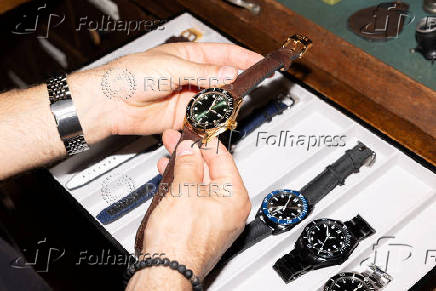 A person holds a DuBois et fils watch, at their showroom in Muttenz