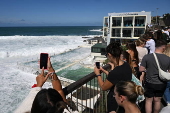 King tide swell destroys windows at Bondi Beach