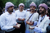 Iraqi Yazidis attend a ceremony on the occasion of Red Wednesday, to celebrate the Yazidi New Year, at Lalish temple in Shekhan District near Duhok province