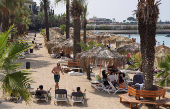 People sit together at a public resort in Latakia