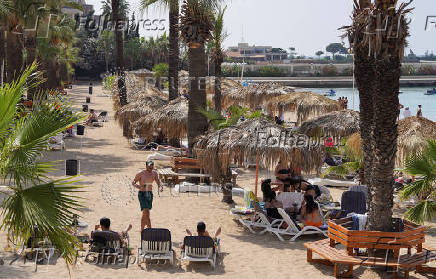 People sit together at a public resort in Latakia