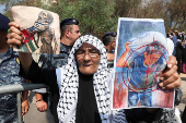 A demonstrator holds signs during a protest against hunger crisis in Gaza, near the embassy of Egypt in Beirut