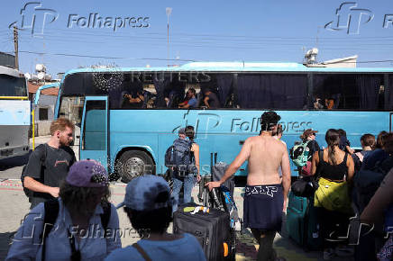 A passenger from the Crown Iris a cruise ship sits in a bus, at the port of Larnaca