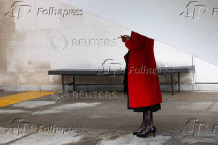 Woman stands under a shelter in a smoking area of the UN headquarters, in New York City