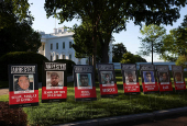 Posters of people described as arrested illegal immigrants are displayed outside the White House in Washington