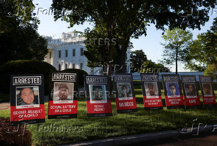 Posters of people described as arrested illegal immigrants are displayed outside the White House in Washington