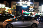 Jordanians celebrate after Jordan qualified for the World Cup for the first time, winning 3-0 over Oman, in Amman
