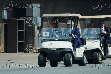 U.S. President Donald Trump rides a golf cart at the Courses at Andrews, Joint Base Andrews