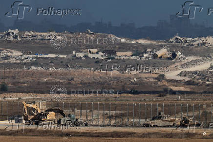 Military vehicles are seen on the Israeli side of the Israel-Gaza border