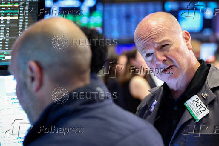 Traders work on the floor of the NYSE in New York
