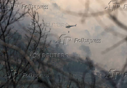 Firefighters battle a wildfire raging in Spain's Avila region