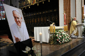 A priest celebrates a Mass next to a picture of late Pope Francis, after the death of the pontiff was announced by the Vatican, in St. John's Cathedral in Warsaw