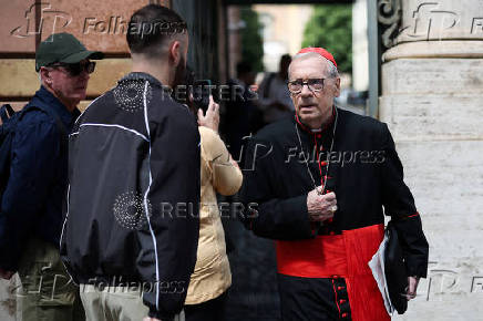 Cardinals walks ahead of the conclave to elect the next pope