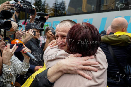 Freed Ukrainian POWs return after a swap in an undisclosed location in Ukraine