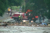 First responders survey rising flood waters of the Guadalupe River after flash flooding in Kerr County