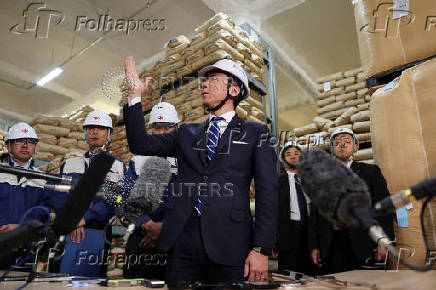 Japan's Agriculture, Forestry and Fisheries Minister Shinjiro Koizumi speaks to the media as he inspects a warehouse storing stockpiled rice in Kanagawa