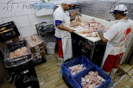 Chicken vendors work in a market in Sao Paulo