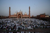 Muslims offer prayers at Jama Masjid on the occasion of Eid al-Adha, in the old quarters of Delhi
