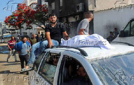 Mourners attend the funeral of Palestinians who were killed, according to medics, in Israeli fire, at Al-Shifa hospital, in Gaza City