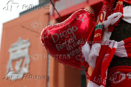 Fans pay their respects outside Anfield Stadium, on the day of the funeral of Liverpool soccer player Diogo Jota in Portugal, in Liverpool
