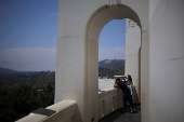 A visitor looks through a telescope at the Griffith Observatory in Los Angeles