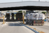 Trucks carrying aid line up at the Kerem Shalom crossing between Israel and Gaza, before going into Gaza, on the Israeli side of the Israel-Gaza border