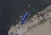A satellite image shows a North Korean warship covered with a blue tarp after an accident that occurred during its launch at the shipyard in Chongjin