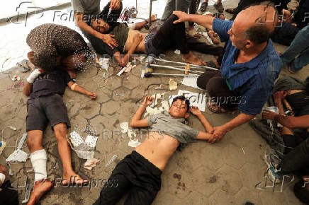 Palestinian casualties are brought to Al-Ahli Arab Hospital following an Israeli air strike near a school sheltering displaced people, in Gaza City
