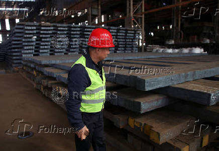 A visitor inspects iron bars in a factory at Dinson Iron and steel company in Mvuma