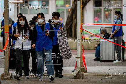 Hong Kong residents affected by the fire gather their belongings from their apartments