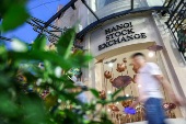 A man walks past Hanoi Stock Exchange, in Hanoi